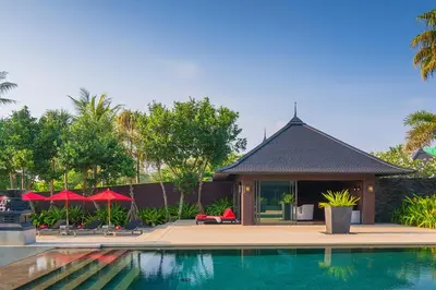 a house with a swimming pool in front of a house at Villa Saanti in Natai Beach