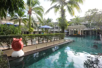 a stuffed animal sits next to a swimming pool at a resort at A2 Pool Resort - SHA Plus in Phuket Town