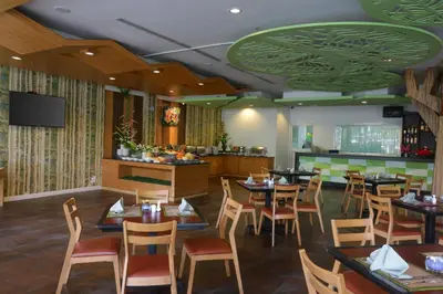 a restaurant with tables and chairs and a bar at A2 Pool Resort - SHA Plus in Phuket Town