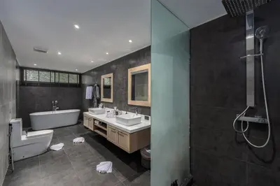 a bathroom with two sinks and a bath tub and a tub at Baan Phu Prana Boutique Villa in Surin Beach