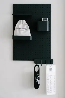 a black pegboard with a baseball cap on a wall at Blu Monkey Phi Phi Island in Phi Phi Don