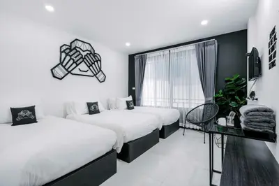 a bedroom with two beds and a window at Blu Monkey Phi Phi Island in Phi Phi Don