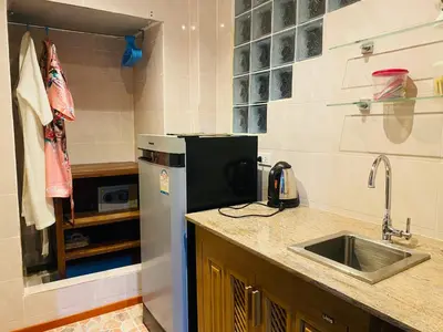a kitchen with a sink and a refrigerator at Krabi Villa Phu Khao Private Resort in Klong Muang Beach