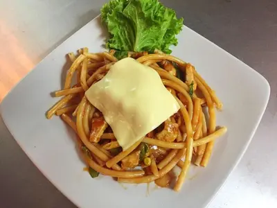 a white plate of pasta with cheese and lettuce at Krabi Villa Phu Khao Private Resort in Klong Muang Beach