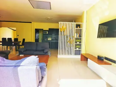 a living room with a couch and a tv at Thai family rawai Swimming pool villa Hotel in Rawai Beach
