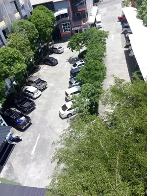 a row of cars parked in a parking lot at SB Living Place Hotel Phuket Town in Phuket Town