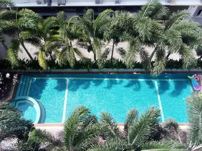 an overhead view of a swimming pool with palm trees at SB Living Place Hotel Phuket Town in Phuket Town