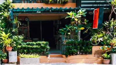 an entrance to a building with a bunch of plants at Sabina Guesthouse Kamala in Kamala Beach