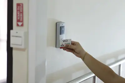 a person is holding a cup in a machine at Baan Kamala Backpacker in Kamala Beach