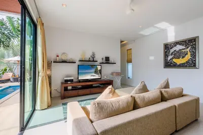 a living room with a couch and a tv at Perfect 3br Pool Villa by Intira Villas in Rawai Beach