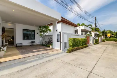 a white house with a driveway in front of it at Perfect 3br Pool Villa by Intira Villas in Rawai Beach