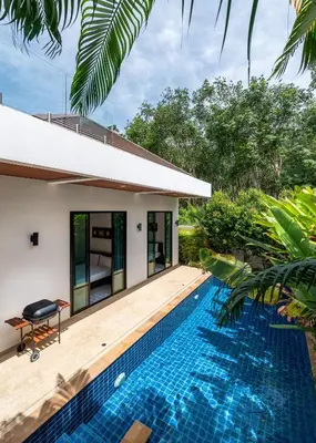 a swimming pool in front of a villa at Modern 3br Boutique Pool Villa by Intira Villas in Rawai Beach