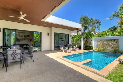 a house with a swimming pool and a patio at West facing 3br Boutique Pool Villa by Intira Villas in Rawai Beach