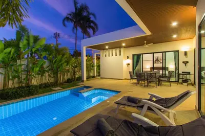 a villa with a swimming pool and a patio at West facing 3br Boutique Pool Villa by Intira Villas in Rawai Beach