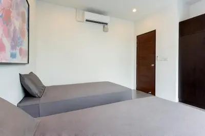 a bedroom with two beds and a door at Large 3br Boutique Villa with big Pool by Intira Villas in Rawai Beach