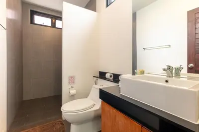 a bathroom with a white toilet and a sink at Thai-Themed 3br Boutique Villa by Intira Villas in Rawai Beach