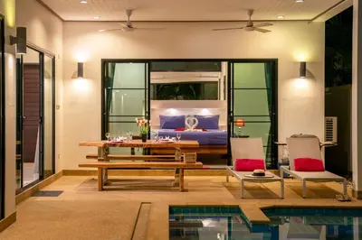 a living room with a table and chairs and a bed at Thai-Themed 3br Boutique Villa by Intira Villas in Rawai Beach