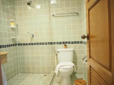 a bathroom with a toilet and a shower at Your Place Inn in Karon Beach