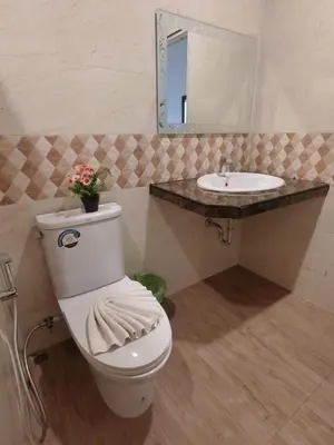 a bathroom with a white toilet and a sink at The Krabi Forest Homestay in Ao Nang Beach