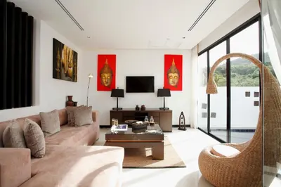 a living room with a couch and a table at By The Lake Villas in Nai Harn Beach
