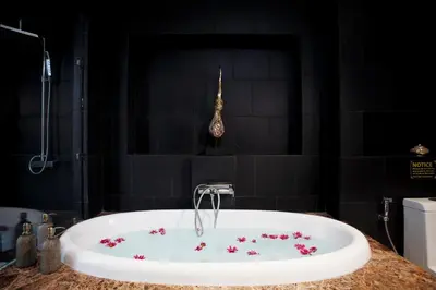 a bathroom with a tub with flowers in it at By The Lake Villas in Nai Harn Beach