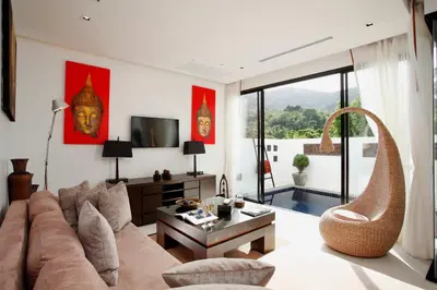 a living room with a couch and a table at By The Lake Villas in Nai Harn Beach