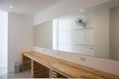 a large mirror on a wall in a room at Nonnee Hotel Kata Beach Phuket in Kata Beach