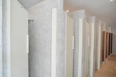 a row of white columns in a hallway at Nonnee Hotel Kata Beach Phuket in Kata Beach