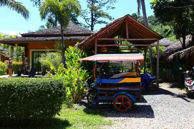 a small cart parked in front of a house at Laguna Villas Boutique Hotel in Ko Yao Noi