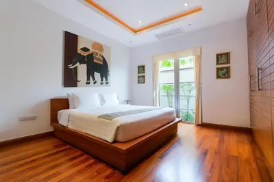 a bedroom with a bed and a painting on the wall at The Residence Bantao Villa unit 121 in Bang Tao Beach