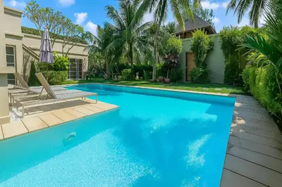 a swimming pool in front of a house at The Residence Bantao Villa unit 121 in Bang Tao Beach