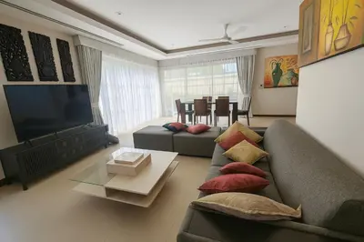 a living room with a couch and a flat screen tv at The Residence Bantao Villa unit 121 in Bang Tao Beach