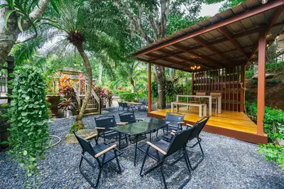 a patio with a table and chairs under a pavilion at Thai Modern Resort & Spa 