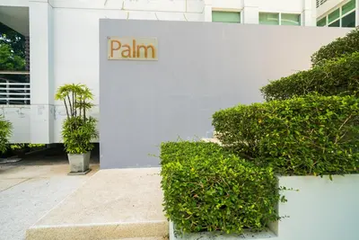a white building with a sign that reads pain at The Palm at Veloche Group by Lofty in Karon Beach