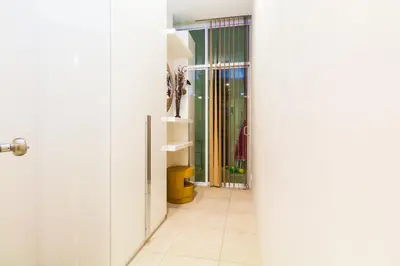 a hallway with a door leading to a bathroom at The Palm at Veloche Group by Lofty in Karon Beach