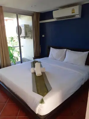 a hotel room with a bed with a towel on it at PorterHouse Beach Hotel in Patong Beach