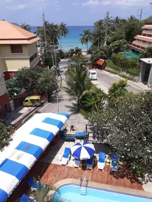 an aerial view of a resort with umbrellas and a pool at PorterHouse Beach Hotel in Patong Beach