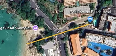 a map of a beach with a street sign and a road at PorterHouse Beach Hotel in Patong Beach