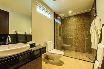 a bathroom with a toilet and a sink and a shower at Dahlia 2 Bedroom Amazing Seaview in Rawai Beach