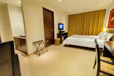 a hotel room with a bed and a desk at Dahlia 2 Bedroom Amazing Seaview in Rawai Beach