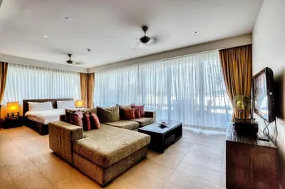 a living room with a couch and a bed in a room at Dahlia 2 Bedroom Amazing Seaview in Rawai Beach