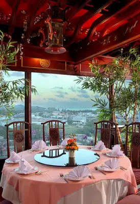 a table with pink tablecloths and napkins on it at Pearl Hotel Phuket in Phuket Town