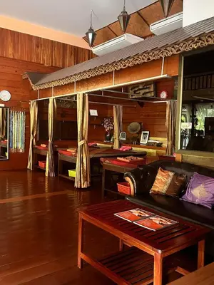 a living room with a couch and a table at Baan Vanida Garden Resort in Karon Beach