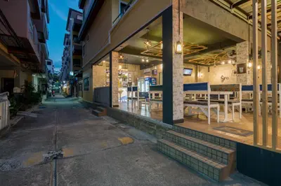 an empty street with a restaurant in a building at Amarin Hotel Patong in Patong Beach