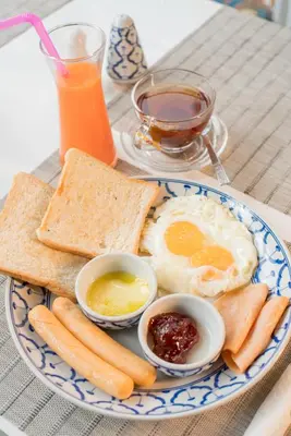 a plate of breakfast food with eggs bread and toast at Amarin Hotel Patong in Patong Beach