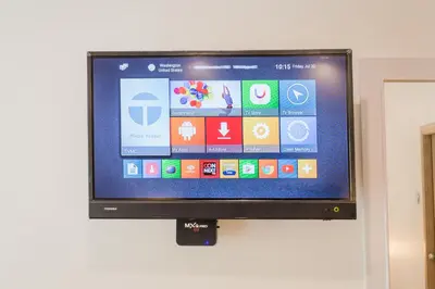 a flat screen tv hanging on a wall at Journey Residence Phuket in Bang Tao Beach
