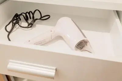 a hair dryer sitting on top of a shelf at Journey Residence Phuket in Bang Tao Beach