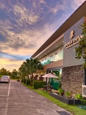 a car parked in front of a building at Journey Residence Phuket in Bang Tao Beach