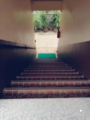 a staircase in a building with a green floor at Smile Home in Patong Beach