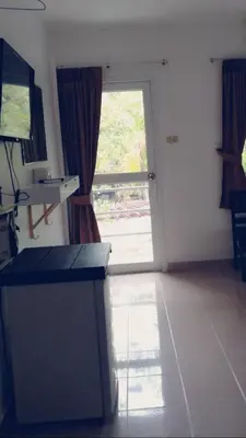a living room with a door and a window at Smile Home in Patong Beach